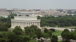 AX74_097 - 4.8K aerial stock footage orbiting the Lincoln Memorial and green trees in Washington DC