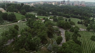 AX74_114 - 4.8K stock footage aerial video flying by rows of grave stones at Arlington National Cemetery, Washington DC