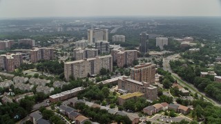 AX74_122E - 4.8K stock footage aerial video flying over apartment complexes, hotel and office buildings in Alexandria, Virginia