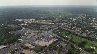 AX74_126E - 4.8K stock footage aerial video approaching shops near homes on Little River Turnpike in Alexandria, Virginia