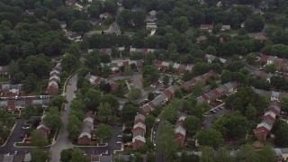 AX74_134 - 4.8K aerial stock footage tilting to a bird's eye view of row houses in Springfield, Virginia