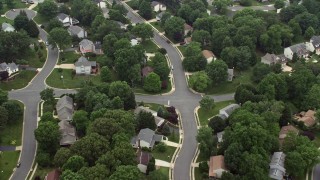 AX74_138 - 4.8K aerial stock footage tilting to a bird's eye view of suburban neighborhood in Burke, Virginia
