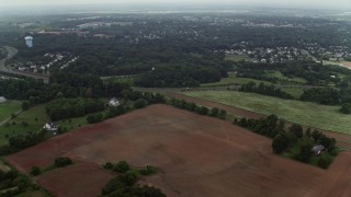 AX74_148E - 4.8K aerial stock footage flying over rural homes and farm fields around Prince William Parkway in Manassas, Virginia
