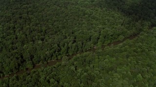 AX75_007 - 4.8K aerial stock footage tilting to reveal the Bull Run River through forest in Clifton, Virginia