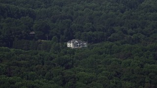 AX75_011 - 4.8K aerial stock footage of an isolated mansion surrounded by green trees, Clifton, Virginia
