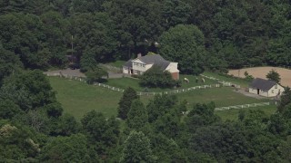 AX75_013 - 4.8K aerial stock footage of an isolated home in the country with horses in Fairfax Station, Virginia