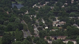 AX75_018 - 4.8K aerial stock footage approaching and tilting to row houses and residential streets in Burke, Virginia
