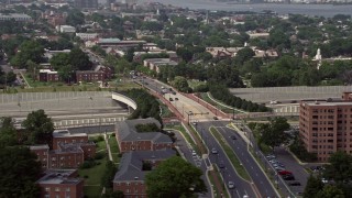 AX75_037E - 4.8K aerial stock footage flying by slow traffic on Interstate 95 near overpass and apartment buildings in Alexandria, Virginia