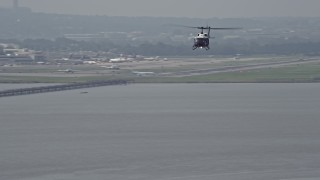 AX75_044 - 4.8K aerial stock footage of a helicopter flying over the Potomac River near Alexandria, Virginia