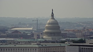 AX75_069E - 4.8K aerial stock footage of the United States Capitol dome behind the James Madison Building in Washington DC