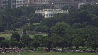 AX75_076 - 4.8K aerial stock footage of the White House partially hidden by trees in Washington DC