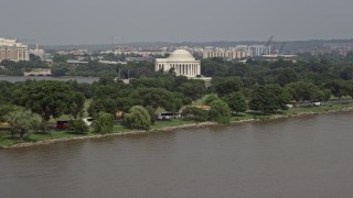 AX75_080 - 4.8K aerial stock footage of Jefferson Memorial seen from the Potomac River in Washington DC