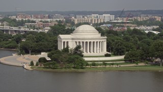 AX75_086 - 4.8K aerial stock footage flying by the Jefferson Memorial, revealing the Jefferson Statue inside in Washington DC