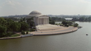 AX75_087 - 4.8K aerial stock footage flying by the Jefferson Memorial to reveal the Jefferson statue inside in Washington DC