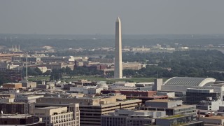 AX75_095 - 4.8K aerial stock footage of the Washington Monument seen from office building rooftops in Washington DC