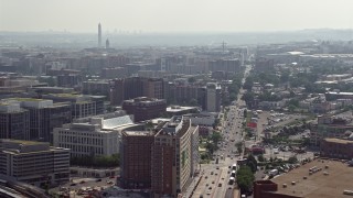 AX75_108 - 4.8K aerial stock footage office buildings on New York Ave with Washington Monument in distance in Washington DC