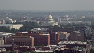 AX75_110 - 4.8K aerial stock footage of office buildings, the United States Capitol, and the Rayburn House Office Building in Washington DC