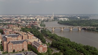 AX75_120E - 4.8K stock footage aerial video of Washington Monument, Francis Scott Key Bridge, and Potomac River seen from Georgetown University in Washington DC