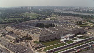 AX75_130E - 4.8K stock footage aerial video orbiting The Pentagon in Washington DC with Potomac River in the background