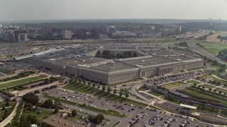AX75_133E - 4.8K stock footage aerial video orbiting around The Pentagon in Washington DC