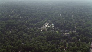AX75_148E - 4.8K aerial stock footage flying over tree-lined neighborhoods in Falls Church, Virginia