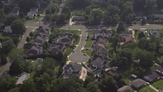 AX75_151 - 4.8K aerial stock footage approaching and tilting to bird's eye of suburban cul-de-sac and homes in Annandale, Virginia