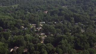AX75_154E - 4.8K aerial stock footage of suburban neighborhoods with trees in Annandale, Virginia