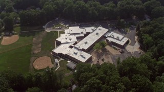 AX75_156 - 4.8K aerial stock footage tilting to bird's eye view of Canterbury Woods Elementary School in Annandale, Virginia