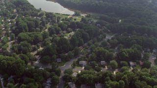 AX75_159E - 4.8K aerial stock footage of a bird's eye view of suburban homes near Lake Royal in Fairfax, Virginia