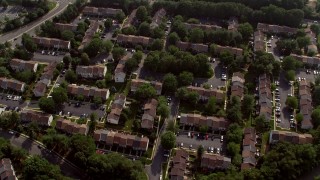 AX75_162 - 4.8K stock footage aerial video tilting to a bird's eye view of row houses in Fairfax, Virginia 