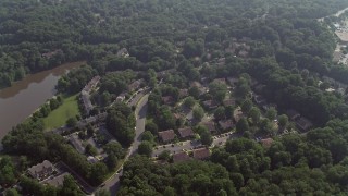 AX75_163 - 4.8K aerial stock footage tilting to a bird's eye view of tract and row houses beside Lake Barton in Burke, Virginia