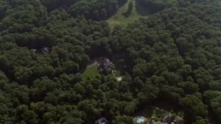 AX75_168 - 4.8K aerial stock footage tilting to a bird's eye view of a beautiful home with pool in Fairfax Station, Virginia