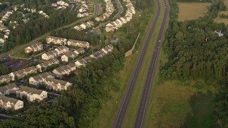 AX76_001 - 4.8K aerial stock footage of Prince William Parkway, residential neighborhoods, Manassas, Virginia, sunset