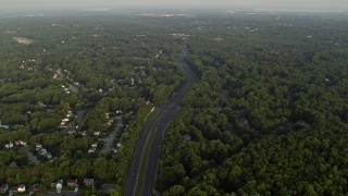 AX76_016 - 4.8K aerial stock footage flying by Fairfax County Parkway, suburban neighborhoods, Burke, Virginia, sunset