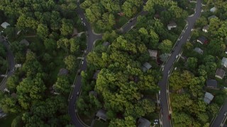 AX76_021 - 4.8K stock footage aerial video of a bird's eye view of neighborhood and high school baseball fields, Springfield, Virginia, sunset