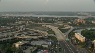AX76_030 - 4.8K aerial stock footage of Interstate 95, Richmond Highway interchange, Alexandria, Virginia, sunset