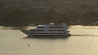 AX76_034 - 4.8K aerial stock footage tracking a ferry sailing the Potomac River, Alexandria, Virginia, sunset