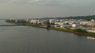 AX76_035 - 4.8K aerial stock footage flying by United States Naval Research Laboratory, Washington, D.C., sunset