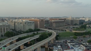 AX76_046 - 4.8K aerial stock footage of Federal Communications Commission and government office buildings in Washington D.C., sunset