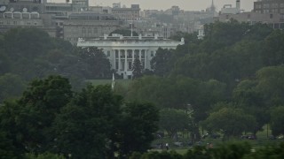 AX76_066 - 4.8K aerial stock footage flying by The White House and the South Lawn Fountain, Washington D.C., sunset