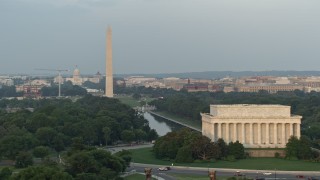 AX76_069 - 4.8K stock footage aerial video flying by Lincoln Memorial, revealing Reflecting Pool, Washington Monument, National Mall, Washington D.C., sunset