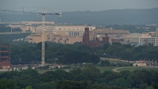 AX76_071 - 4.8K aerial stock footage of Smithsonian Castle in Washington D.C., sunset
