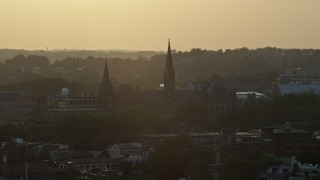 AX76_073 - 4.8K aerial stock footage flying by Georgetown University, Washington D.C., sunset