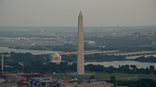 AX76_078E - 4.8K aerial stock footage of Washington Monument and Jefferson Memorial, Ronald Reagan Airport in background, Washington D.C., sunset