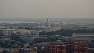 AX76_086 - 4.8K aerial stock footage of the United States Capitol behind the Russell Senate Office Building, Washington D.C., sunset