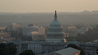 AX76_089 - 4.8K aerial stock footage of the United States Capitol, revealing Washington Monument, Washington D.C., sunset
