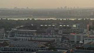 AX76_093 - 4.8K aerial stock footage of Nationals Park, crowded stadium, Ronald Reagan Airport in the background, Washington D.C., sunset