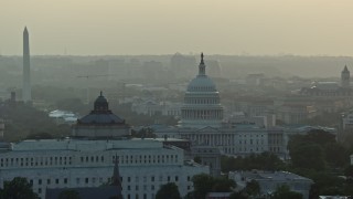 AX76_096 - 4.8K aerial stock footage Library of Congress, United States Capitol, Washington Monument, Supreme Court, Washington D.C., sunset