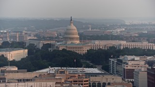 AX76_100E - 4.8K aerial stock footage of Russell Senate Office Building and United States Capitol in Washington D.C., sunset