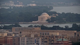 AX76_107E - 4.8K aerial stock footage of tourists at the Jefferson Memorial in Washington D.C., sunset